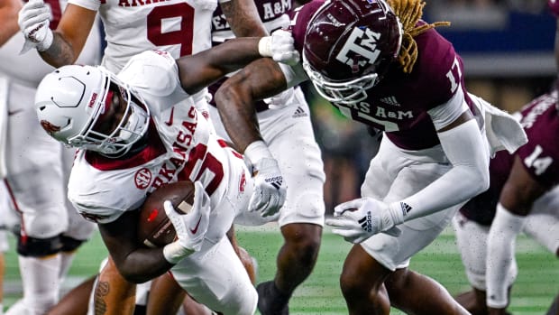 Sep 24, 2022; Arlington, Texas, USA; Arkansas Razorbacks running back Rashod Dubinion (6) is thrown to the ground by Texas A&M Aggies defensive back Jaylon Jones (17) during the second half at AT&T Stadium. Mandatory Credit: Jerome Miron-USA TODAY Sports